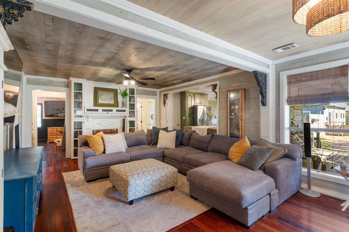 3562 Bob Tolbert Road Navarre, FL 32566 - Photo 9 of 55 a living room with furniture wooden floor and a fireplace