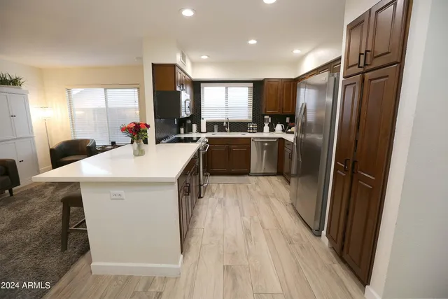 a kitchen with a sink refrigerator and microwave