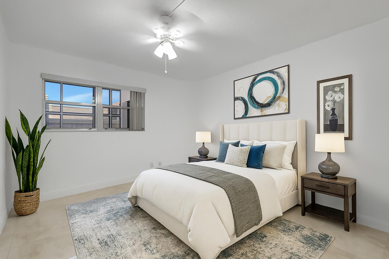 21 Brittany F, Unit A Delray Beach, FL 33446 - Photo 11 of 41 a bedroom with a bed and a potted plant