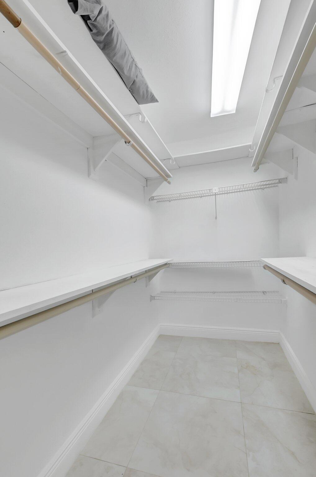 21 Brittany F, Unit A Delray Beach, FL 33446 - Photo 17 of 41 a view of an empty walk in closet