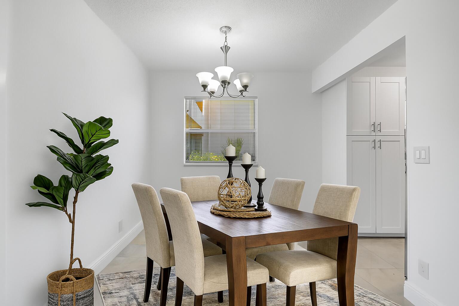 21 Brittany F, Unit A Delray Beach, FL 33446 - Photo 6 of 41 a view of a dining room with a table and chairs