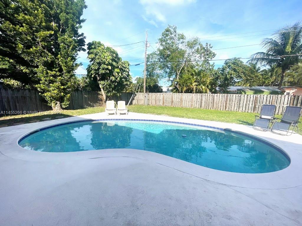 a view of a swimming pool and a yard