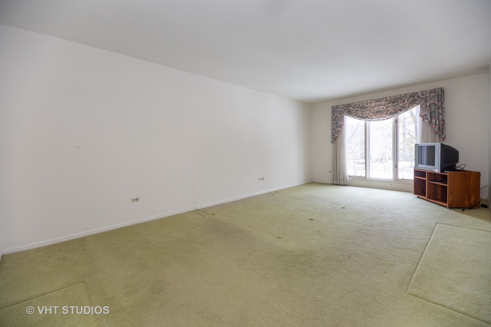 1800 Mission Hills Road, Unit 210 Northbrook, IL 60062 - Photo 12 of 16 a view of an empty room with a fireplace and a window