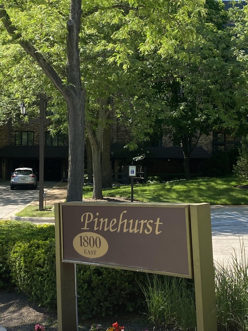 1800 Mission Hills Road, Unit 210 Northbrook, IL 60062 - Photo 3 of 16 a view of street with sign board and yard