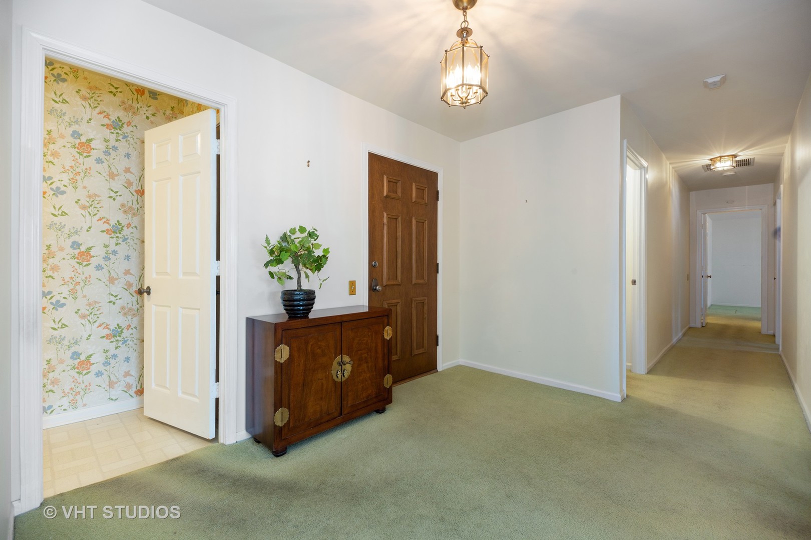 1800 Mission Hills Road, Unit 210 Northbrook, IL 60062 - Photo 9 of 16 a view of a hallway to a livingroom and a chandelier