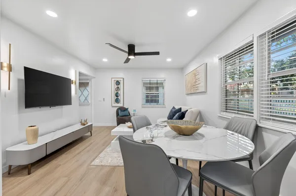 a living room with furniture flat screen tv and window