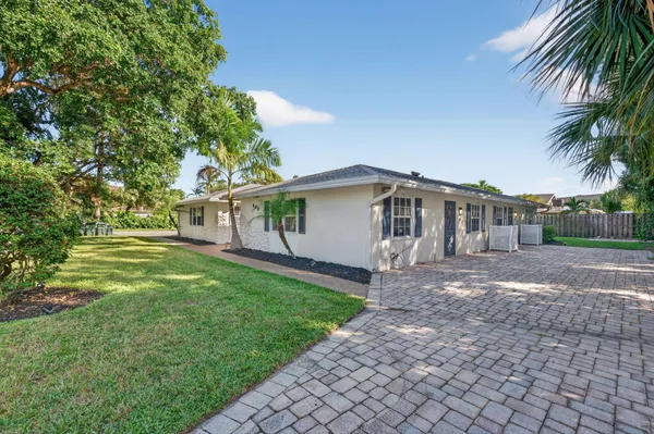 a kitchen with cabinets appliances a sink and a window