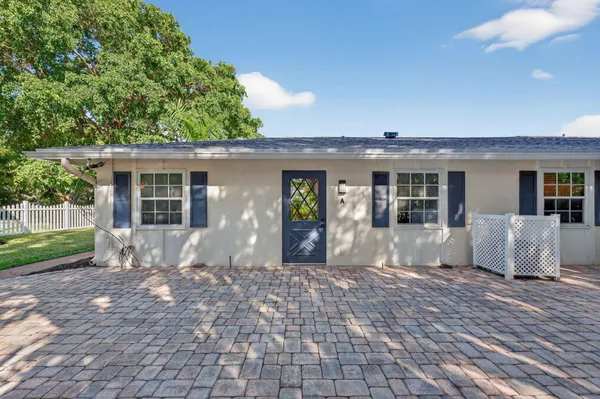 a bathroom with a sink a toilet a mirror and shower