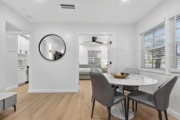 a view of a dining room with furniture window and wooden floor