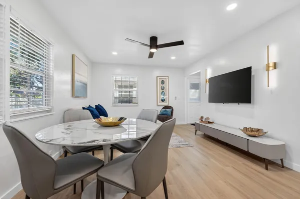 a kitchen with stainless steel appliances granite countertop a sink a stove a refrigerator and cabinets