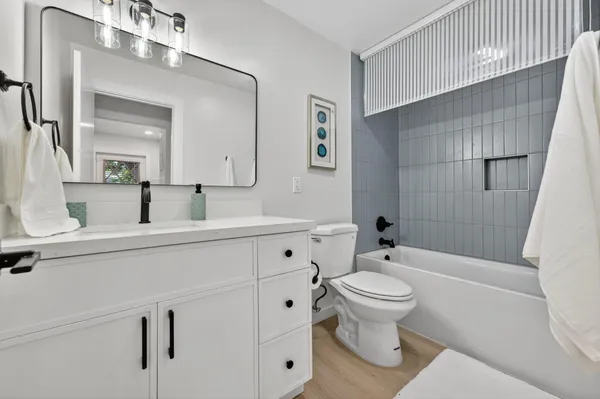 a bedroom with a bed and a ceiling fan