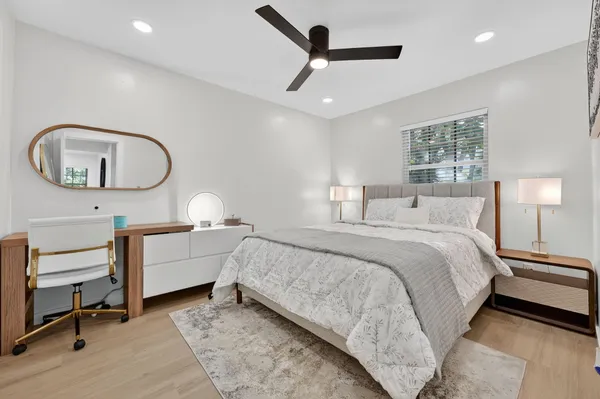 a bedroom with a large bed and a window