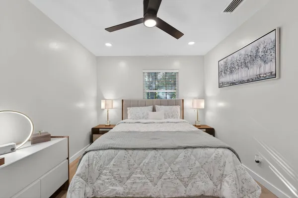 a bedroom with a large bed and a window