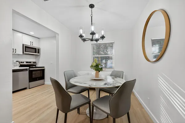 an aerial view of a house with a yard and parking spaces