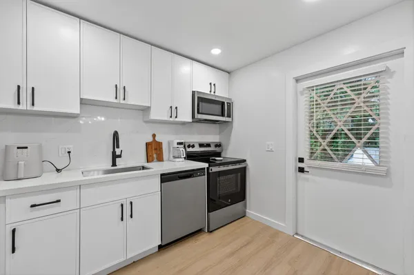 an aerial view of residential houses with city view