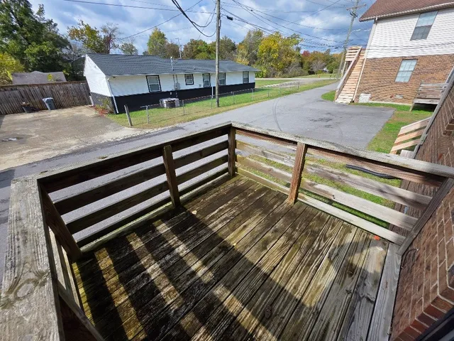 a view of a wooden deck with a yard