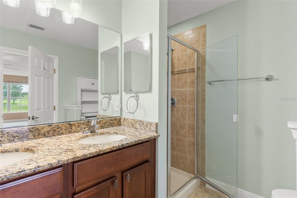 868 Assembly Court Reunion, FL 34747 - Photo 25 of 43 a bathroom with a granite countertop sink and a mirror