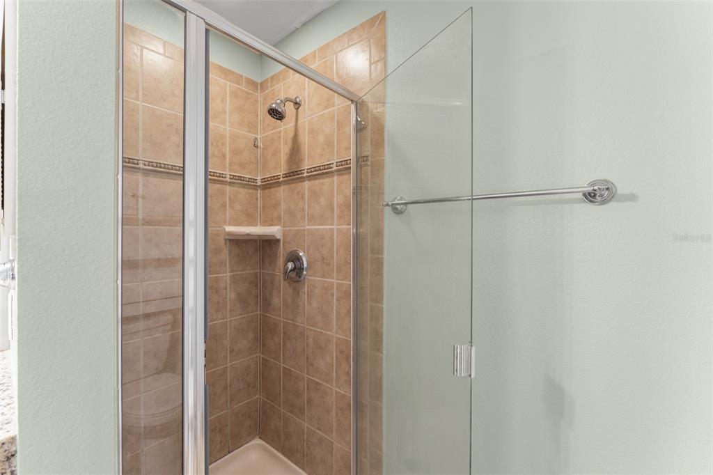 868 Assembly Court Reunion, FL 34747 - Photo 26 of 43 a bathroom with a glass shower door