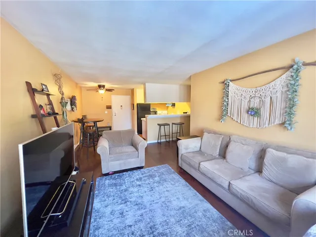 a view of a dining room with furniture and a chandelier