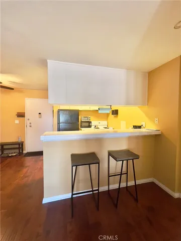 a room with a sink a stove and a refrigerator