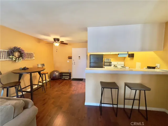 a kitchen with stainless steel appliances a refrigerator a sink a stove and white cabinets