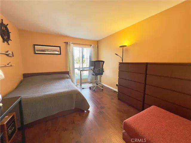 a large white room with a large window and furniture