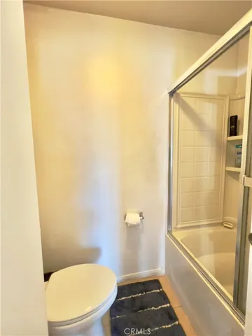 a view of swimming pool with lawn chairs and plants