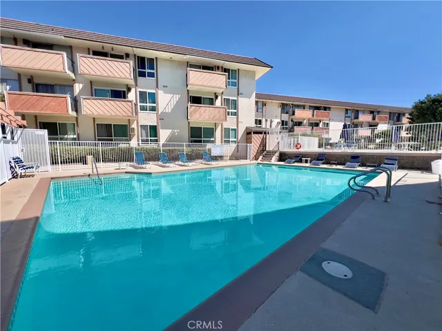 a building outdoor space with patio furniture and a potted plant