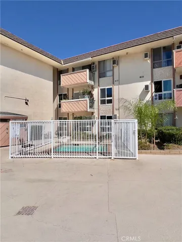 a living room with furniture gym equipment and a large window