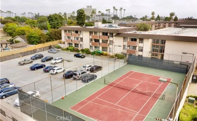a yellow building with trees in front of it