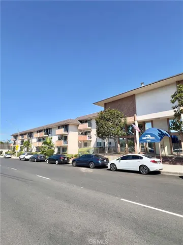 a view of a cars parked on the side of a street