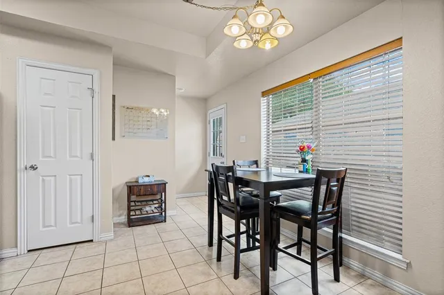 a view of a dining room with furniture and chandelier