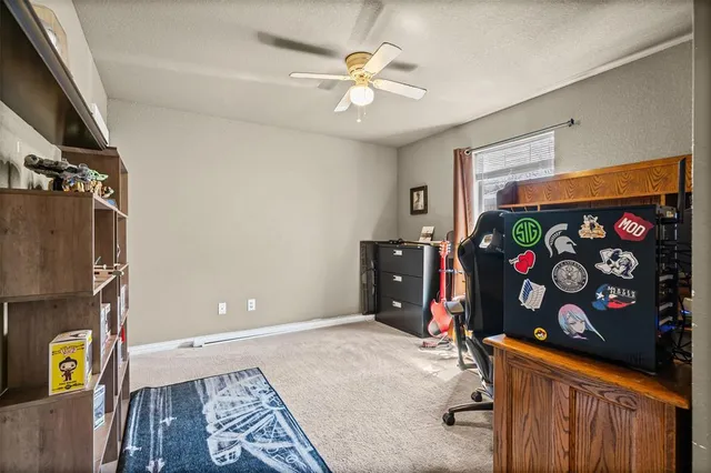 walk in closet with window and a chandelier