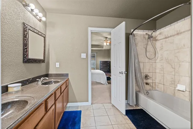 a bathroom with a sink a vanity a mirror and a bathtub