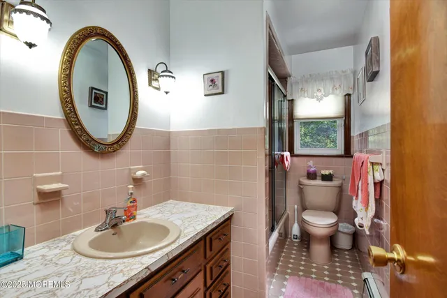 a bathroom with a sink shower and a mirror