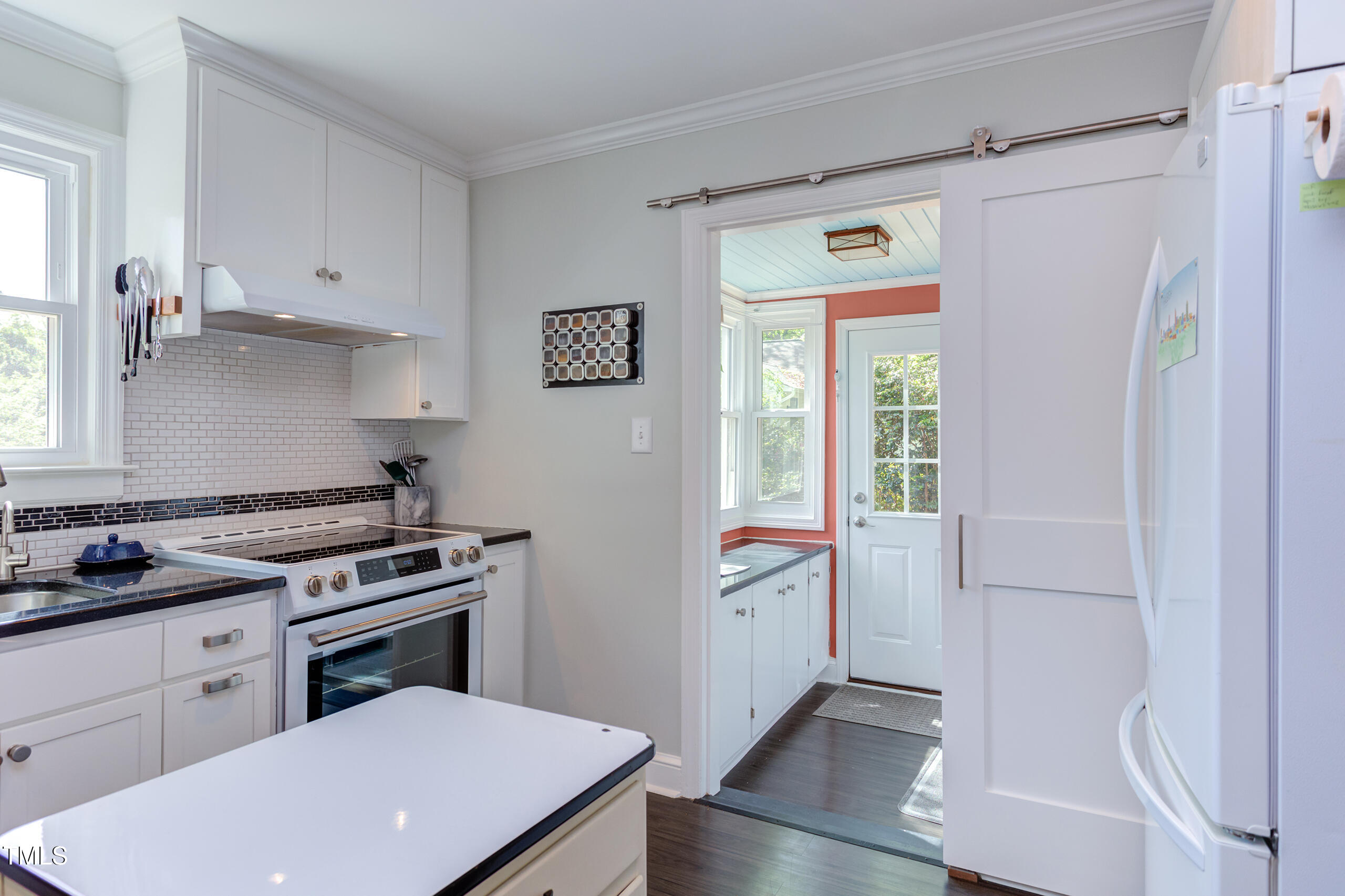2811 Van Dyke Avenue Raleigh, NC 27607 - Photo 15 of 57 a kitchen with a stove a refrigerator and a window