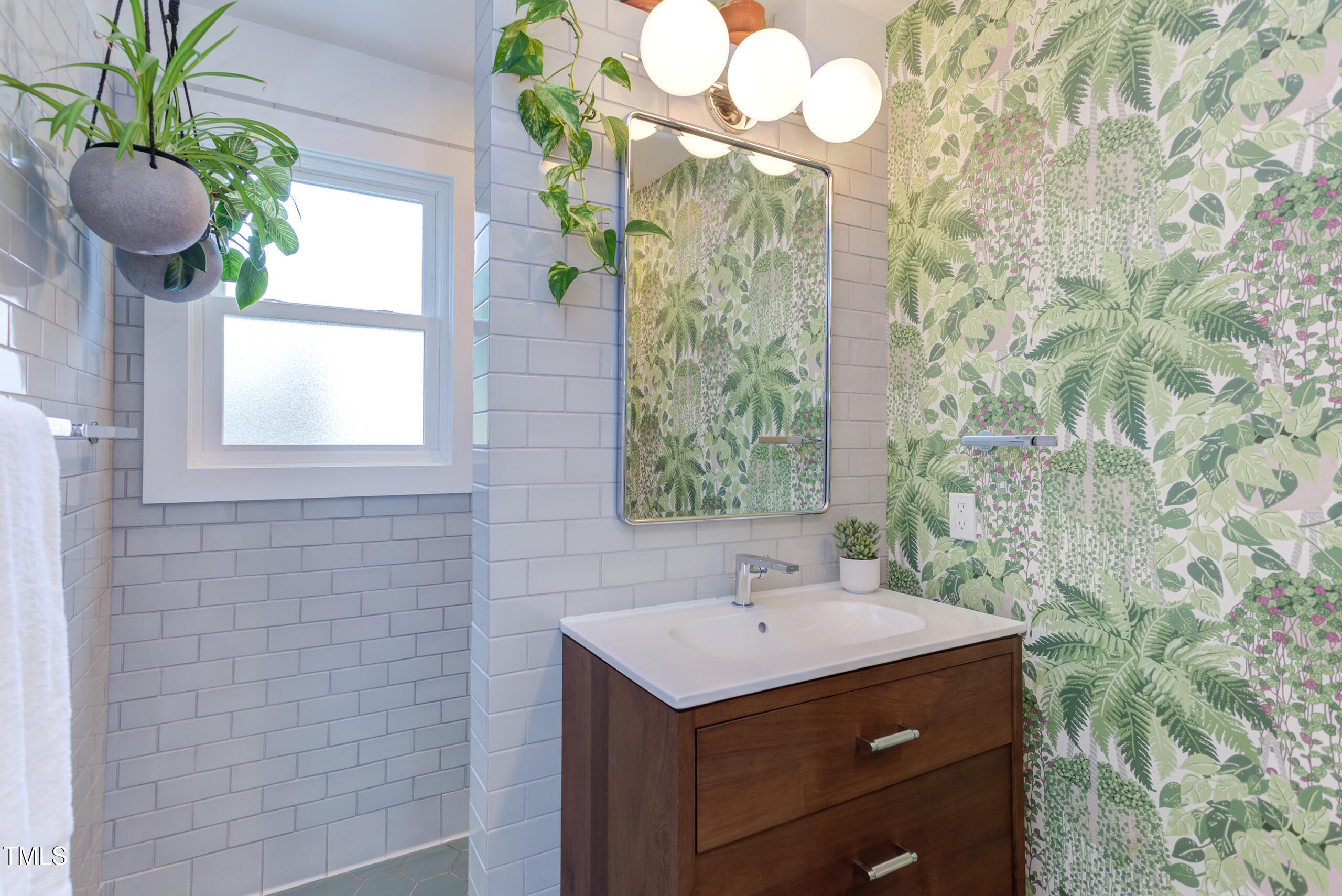 2811 Van Dyke Avenue Raleigh, NC 27607 - Photo 28 of 57 a bathroom with a sink a mirror and a shower