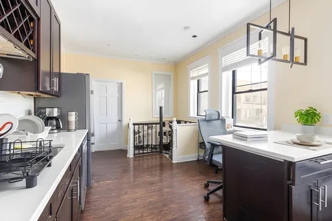 a kitchen with a table chairs stove and cabinets