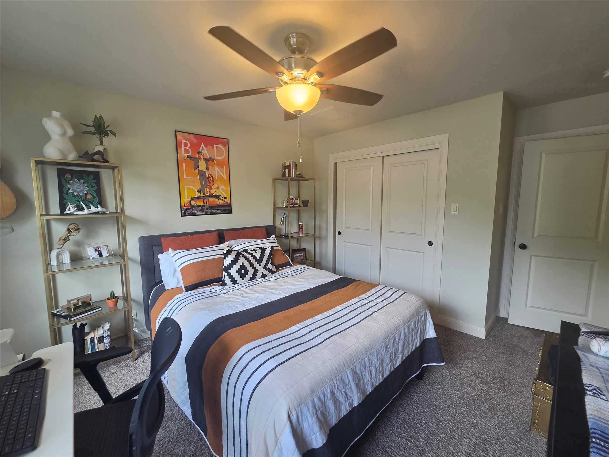 408 West Croslin Street Austin, TX 78752 - Photo 20 of 29 A comfortable bedroom features carpet flooring and a practical ceiling fan for year-round comfort.