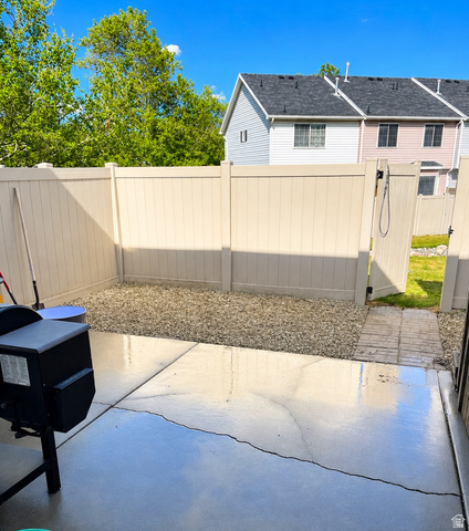 819 South Canyon Road Payson, UT 84651 - Photo 18 of 18 Paved patio space featuring a gravel-covered yard area, full privacy fencing, and a fenced gate providing exterior access