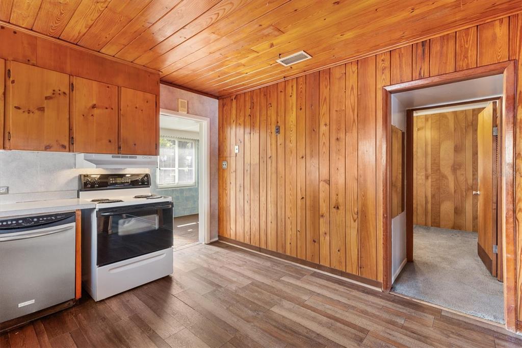 5605 Berts Road Lady Lake, FL 32159 - Photo 12 of 38 a kitchen with granite countertop wooden cabinets and stainless steel appliances