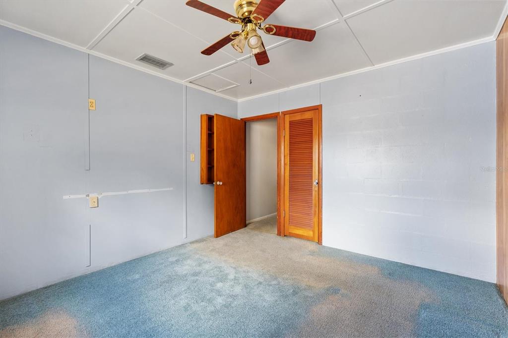 5605 Berts Road Lady Lake, FL 32159 - Photo 19 of 38 an empty room with closet and a chandelier fan