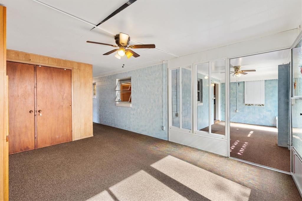 5605 Berts Road Lady Lake, FL 32159 - Photo 20 of 38 a view of a livingroom with a chandelier fan and windows