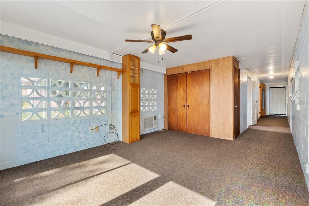 5605 Berts Road Lady Lake, FL 32159 - Photo 21 of 38 a view of a hallway with a ceiling fan