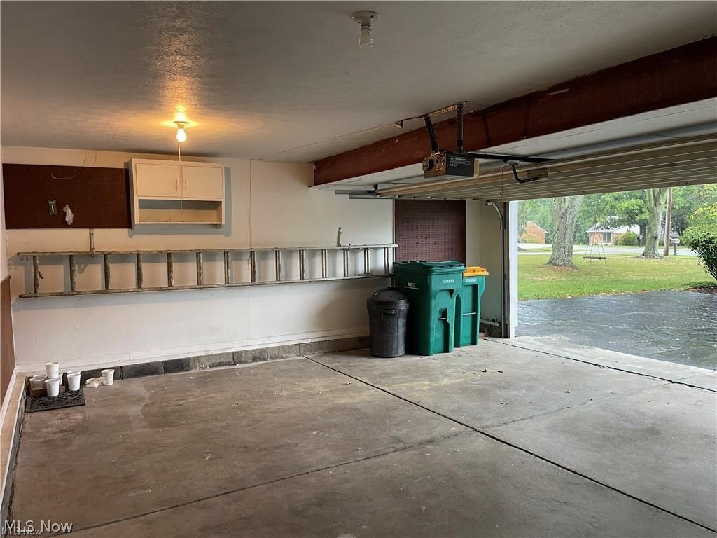2800 Hillside Road Seven Hills, OH 44131 - Photo 14 of 18 Garage space featuring a concrete floor and white painted walls
