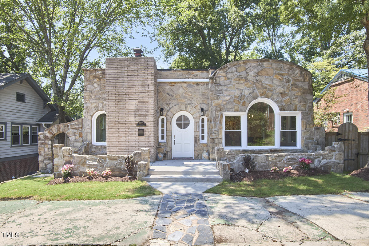 a front view of a house with garden