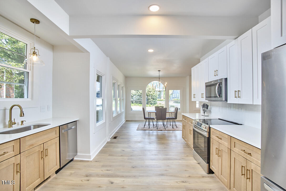 2203 University Drive Durham, NC 27707 - Photo 12 of 40 a large kitchen with stainless steel appliances lots of counter space and a sink