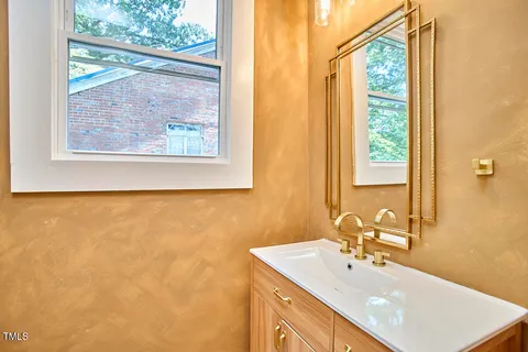 a bathroom with a sink and a large mirror