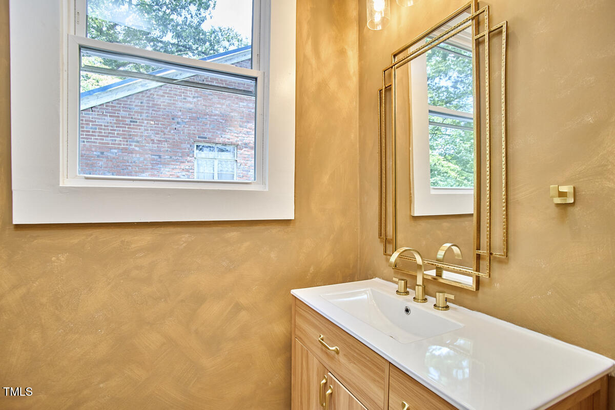 2203 University Drive Durham, NC 27707 - Photo 14 of 40 a bathroom with a sink and a large mirror
