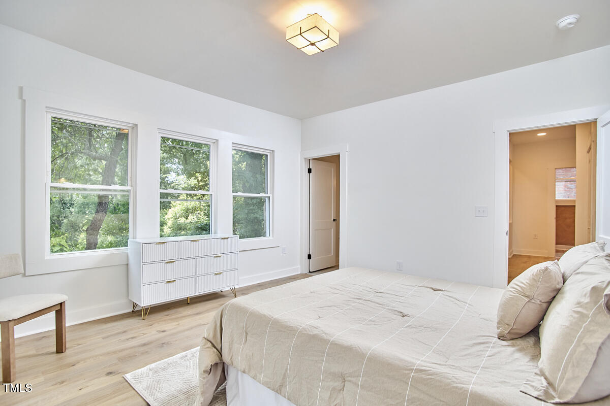 2203 University Drive Durham, NC 27707 - Photo 19 of 40 a bed sitting in a bedroom next to a window